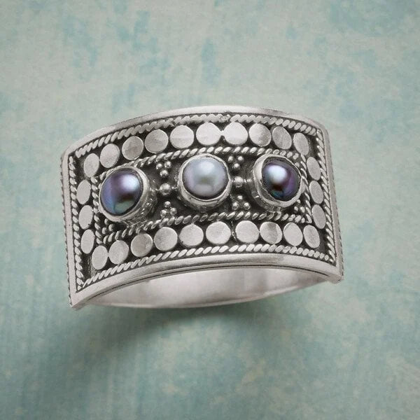 Elegant geometric ring with intricately carved pearl and sparkling stones