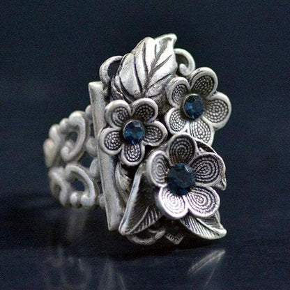 Blooming sapphire ring with floral accents