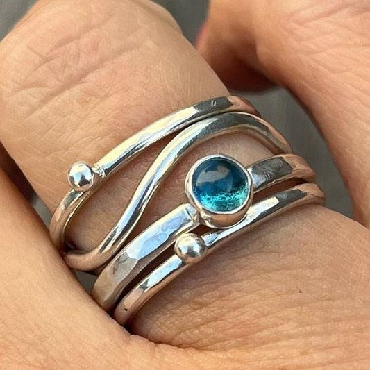 Elegant layered ring with radiant blue crystal