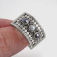 Elegant geometric ring with intricately carved pearl and sparkling stones