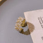 Elegant gold ring with radiant pearls