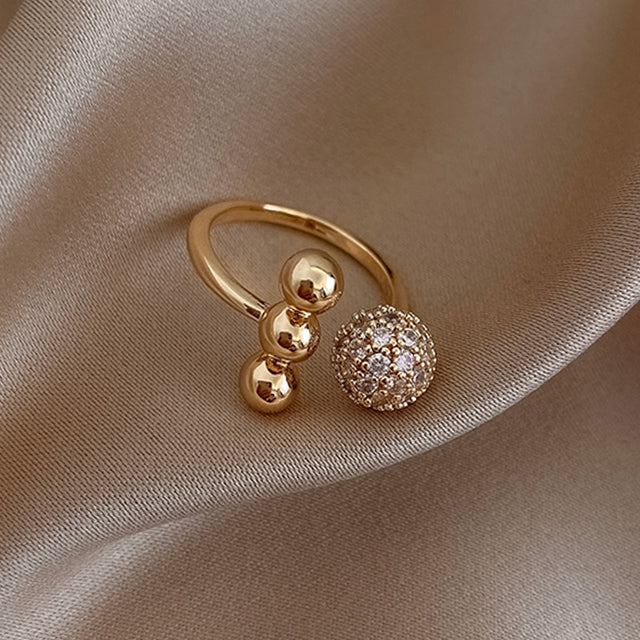 Elegant gold ring with sparkling zirconium dioxide triple beads