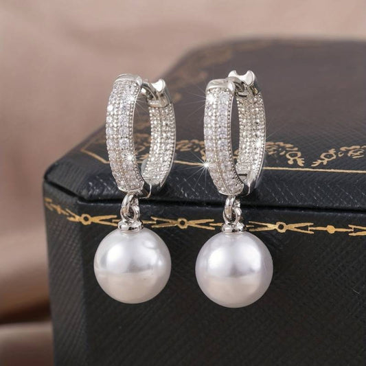 Elegant Silver Earrings Adorned with Radiant Shimmering Pearls