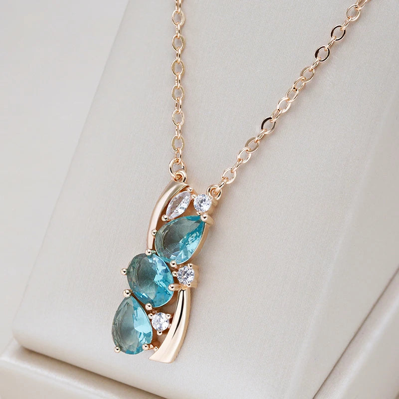 Stylish gold necklace with sparkling blue crystal
