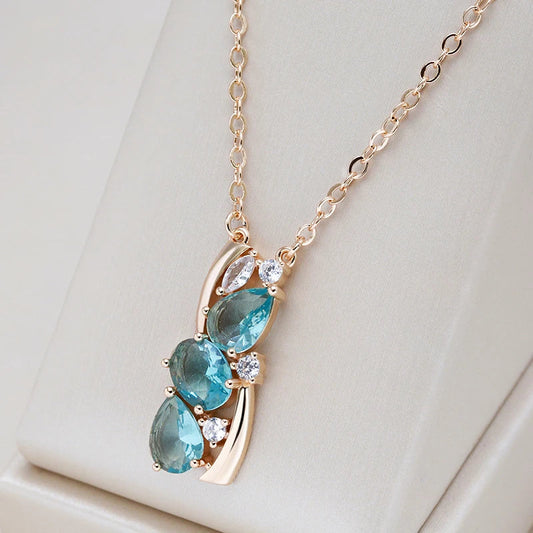 Stylish gold necklace with sparkling blue crystal
