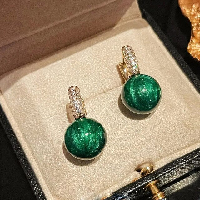 Elegant gold earrings with green pearls