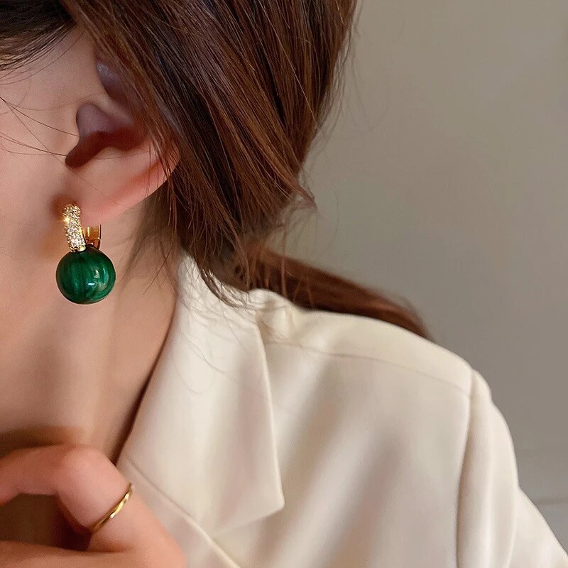 Elegant gold earrings with green pearls