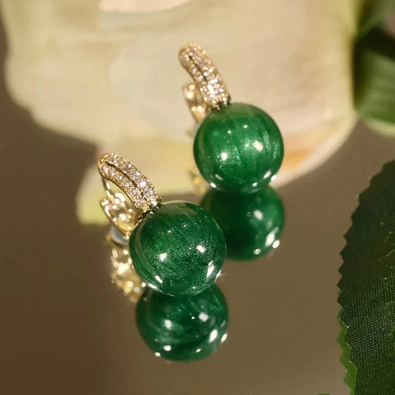 Elegant gold earrings with green pearls