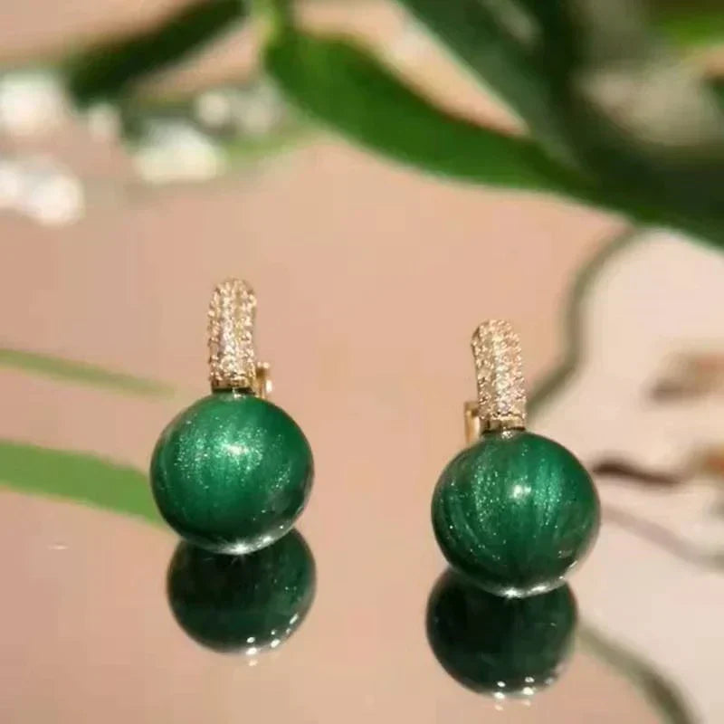 Elegant gold earrings with green pearls