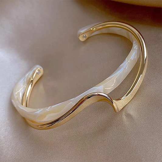 Stylish open bracelet made of elegant white enamel with gold accents