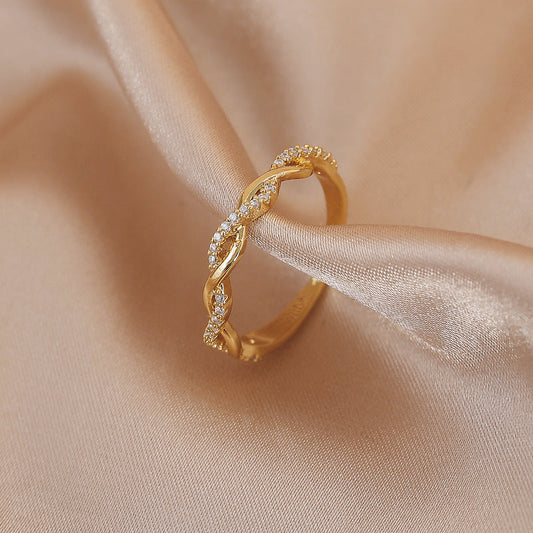 Elegant adjustable ring with woven zirconia stones in radiant gold