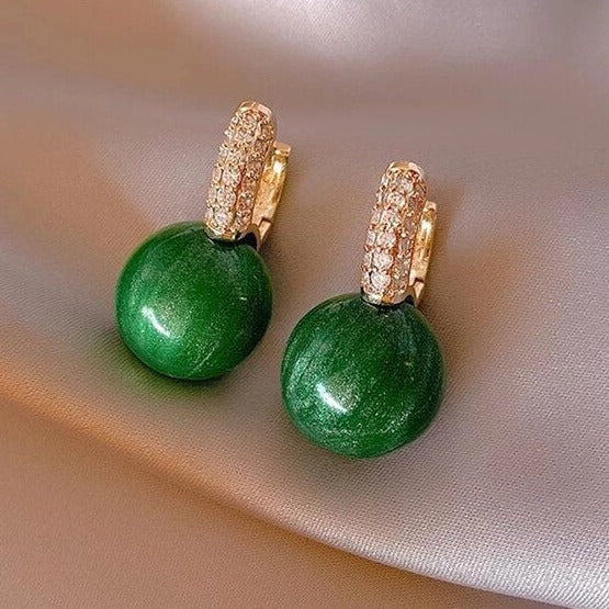 Elegant gold earrings with green pearls