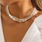 Elegant necklace with white stones and golden pearls