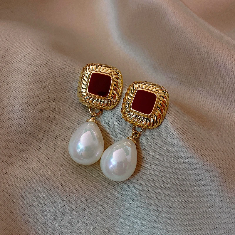 Chic Gold Earrings Featuring Striking Red Accents and Luxurious Pearls