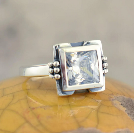 Elegant square glass ring with intricate inlays