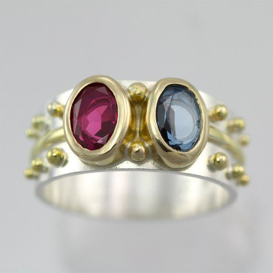 Elegant vintage ring with radiant blue and red crystal