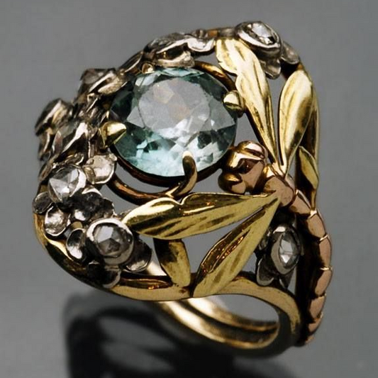 Elegant vintage gold ring with sparkling blue crystal in floral design