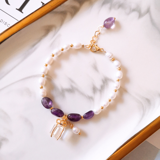 Elegant bracelet made of gold with purple gemstones and sparkling pearls